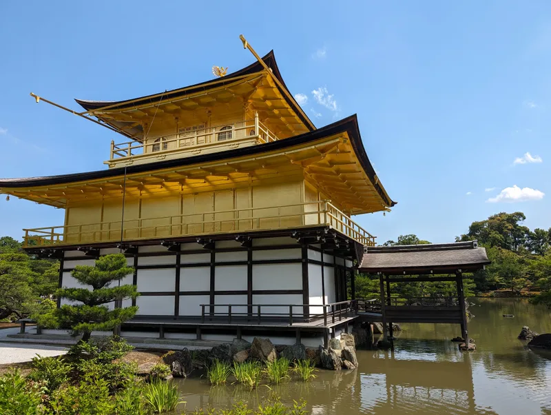Kinkaku-ji Golden Pavilion with wooden walkway over pond in Kyoto, Japan.