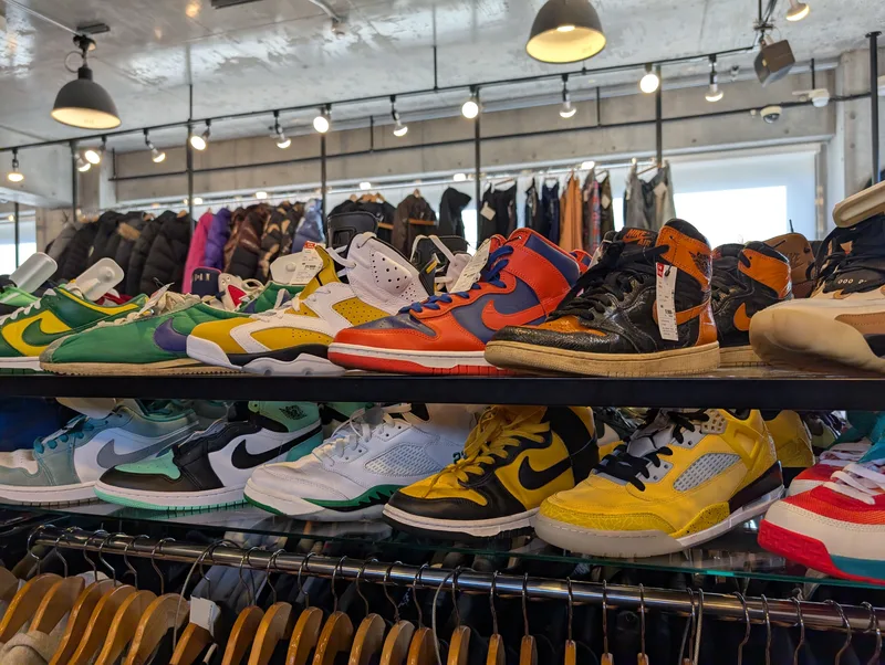 Display of Air Jordan and Nike Dunk sneakers on glass shelves inside a secondhand store in Harajuku, Tokyo, Japan
