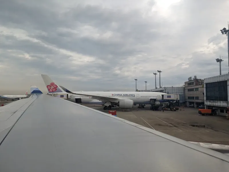 China Airlines plane at airport gate under cloudy sky