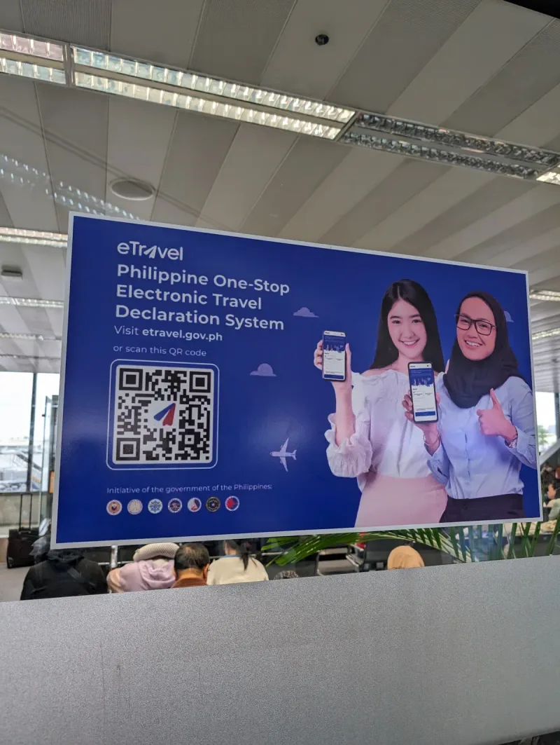 The eTravel system — a frustrating experience Philippine eTravel declaration system sign with QR code