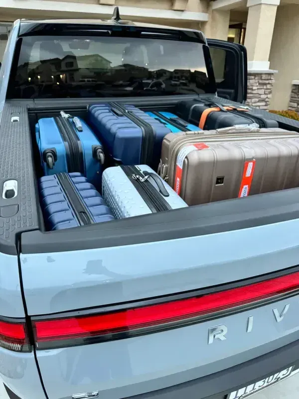 Loading up the R1T for the airport run Rivian truck bed packed with suitcases for travel