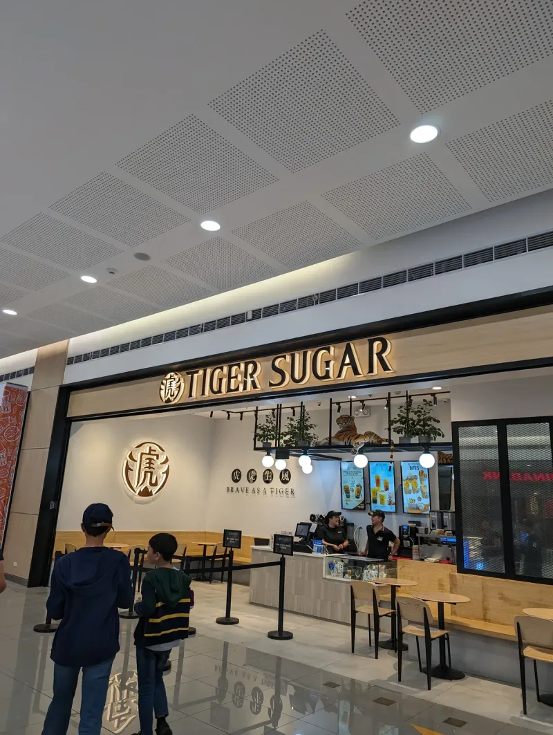 First stop — Tiger Sugar for some bubble tea Tiger Sugar bubble tea shop in a brightly lit mall