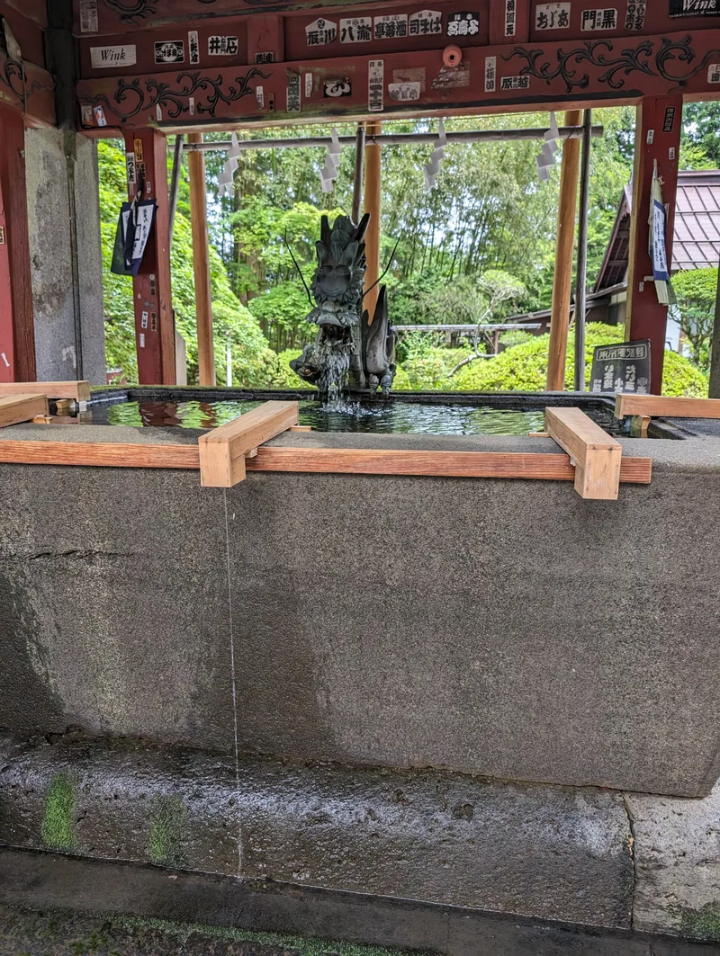 Bronze dragon spout over a temizuya ritual water basin at Fuji Sengen-Jinja Shrine, Fujiyoshida, Yamanashi, Japan.