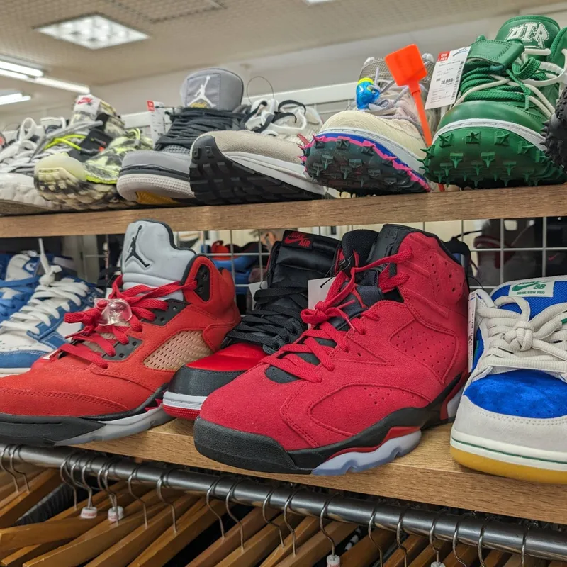 Red and black Air Jordan sneakers on a shelf at Second Street resale store in Japan.