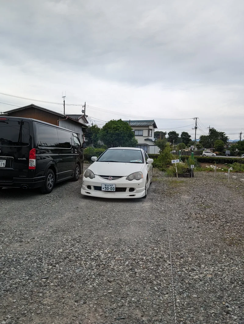 White Honda Integra Type R parked on a street in Japan.