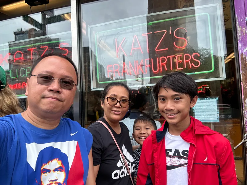 Katz's Deli — the line is always long for a reason Family selfie in front of Katz's Delicatessen neon sign