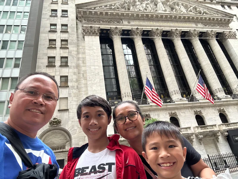 The New York Stock Exchange — even on a Sunday it's impressive Family selfie in front of New York Stock Exchange with American flags