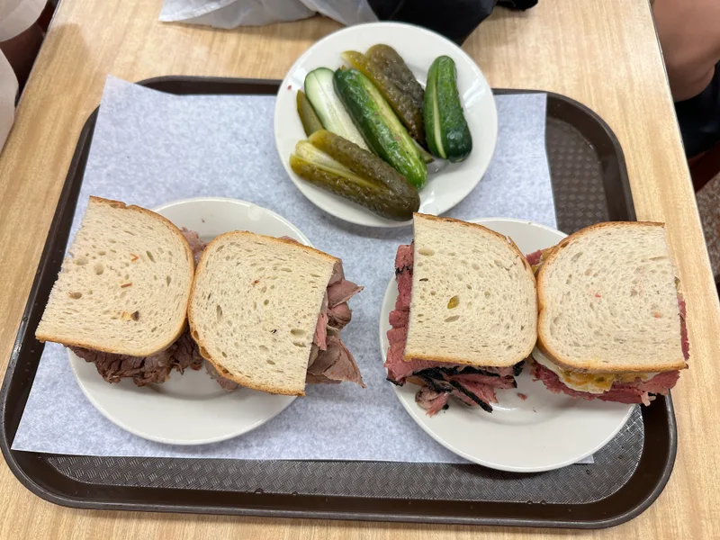 That pastrami. Just look at it. Pastrami sandwiches on rye with pickles at Katz's Delicatessen