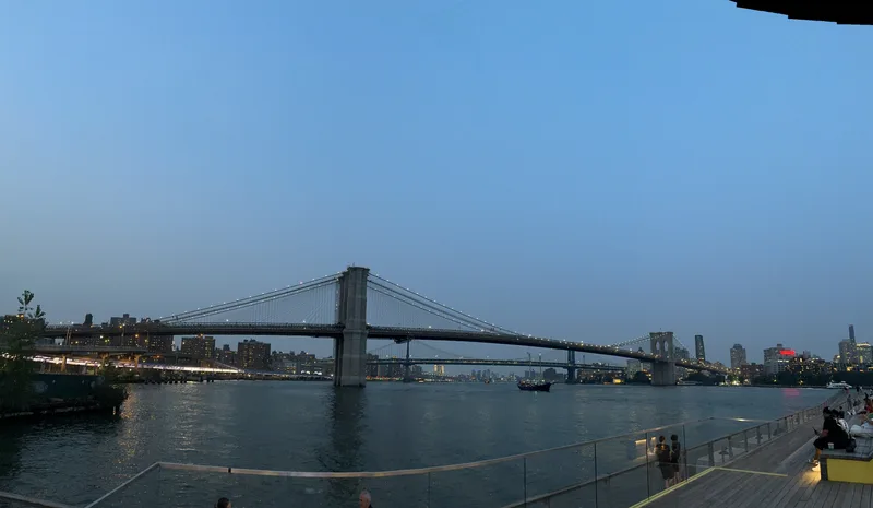 Brooklyn Bridge and Manhattan Bridge at dusk — one of my favorite shots from the whole trip Panoramic view of Brooklyn and Manhattan Bridges with illuminated NYC skyline at dusk
