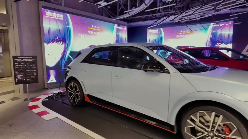 Light blue Hyundai Ioniq 5 N electric car on display indoors in Shibuya, Tokyo, Japan, with anime graphics on large digital screens in the background.
