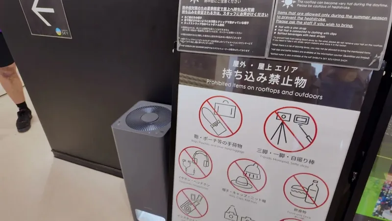 Shibuya Sky sign listing prohibited items including tripods, selfie sticks, and food for rooftop access, Tokyo, Japan.