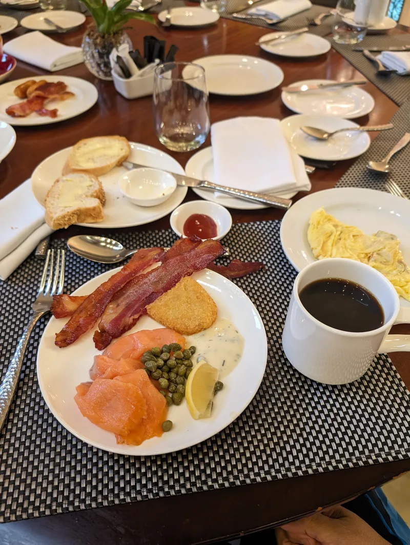 Breakfast plate with smoked salmon, bacon, hash brown, and black coffee from the Spiral buffet at Sofitel Philippine Plaza.
